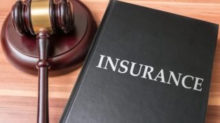 Book with insurance laws. Justice and legislation concept.